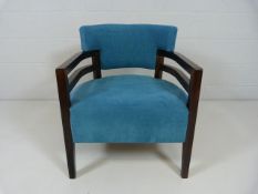 Blue open armchair on darkwood legs