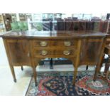 Edwardian mahogany sideboard on Tapering legs with inlay to cupboards, drawers and top.