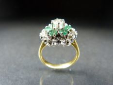 Yellow Gold diamond and emerald ring in the daisy style