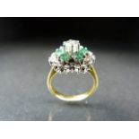 Yellow Gold diamond and emerald ring in the daisy style