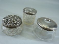 Three silver topped dressing table pots