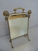 Art Nouveau brass framed fire screen with bevelled glass panel inset.