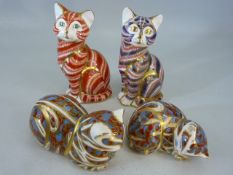 Four Crown Derby cats, two sitting, two sleeping