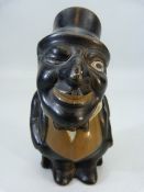 China figure of a minstrel style figure wearing a top hat and tails, possibly depicting Jim Crow: