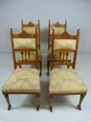 Set of four Arts and Crafts oak dining chairs with domed top and tall sides. Carving to splats