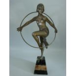 Bronze figure of a scantily clad lady in the Art deco style with a hoop. Mounted on marble plinth