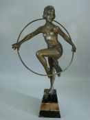 Bronze figure of a scantily clad lady in the Art deco style with a hoop. Mounted on marble plinth