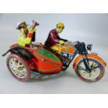 German Tinplate clockwork lithograph motor bike with side car.