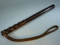 Turned wooden police truncheon with leather strap