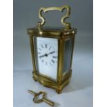 Brass French shaped carriage clock - Key attached. 5 bevelled glass panels. A/F