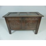 Antique carved coffer on plank feet