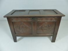 Antique carved coffer on plank feet