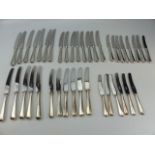 Large selection of silver coloured handled knives.