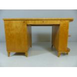 Art Deco kneehole desk with central draw and cupboard to left on splayed feet with white upholstered