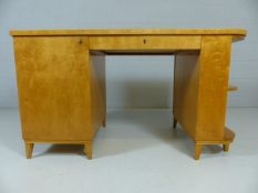 Art Deco kneehole desk with central draw and cupboard to left on splayed feet with white upholstered