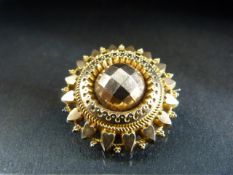 Victorian Etruscan style mourning brooch of rolled gold and numbered to the reverse 52565 in leather