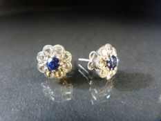 Hallmarked silver earrings set with paste and central sapphire.