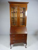 Mahogany Bureau Bookcase with fall front on Cabriole legs. The two door bookcase over with Art
