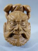 Japanese Carved wooden Netsuke - depicting a mans face. Marked to back