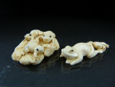 Netsuke: A pair of Antique Japanese bone carvings of frogs frolicking (the pair of frogs signed to
