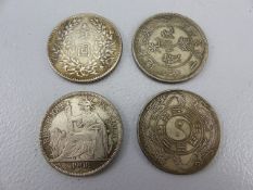 Three chinese silver tokens and a 1908 Republique Francaise Piastre de Commerce.