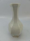 Six sided oriental vase with tapering fluted neck. Simply decorated with light pressings of