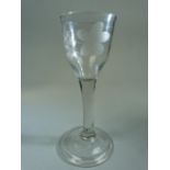 Georgian drinking glass with clear stem on a Double glass foot. Later wheelcut etching to glass bowl
