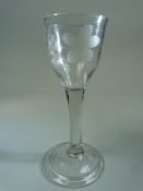 Georgian drinking glass with clear stem on a Double glass foot. Later wheelcut etching to glass bowl