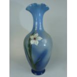 Continental Vase with fluted Top and Hand painted decoration of White daffodils on a blue ground.