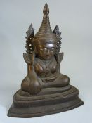 Bronze figure of seated Buddha with Right hand palm facing shin and other resting on the lap.