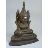 Bronze figure of seated Buddha with Right hand palm facing shin and other resting on the lap.