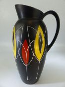 1950's Brentleigh Ware black vase with handle - having a bright yellow interior and decorated with