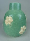 Poole Pottery Freeform Globular squat vase with applied vine and leaf decoration on a turquoise