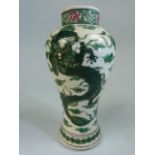 Small oriental vase depicting a five clawed dragon on white ground