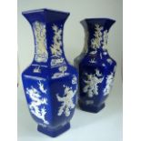 A Pair of Chinese Blue and White Hexagonal vases with depictions of dragons created with raised