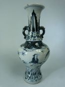 Blue and White Chinese vase depicting seated figures in a garden