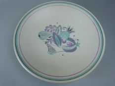 1950's Poole Pottery charger decorated with tones of purple and green. Approx 33cm Diameter.