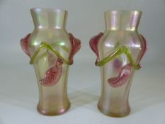 Loetz style pair of iridescent vases with applied green and pink trailing flowers
