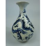 Japanese blue and white bottle vase of squat form. Depicting three clawed dragon. No markings.