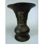 Oriental Bronze fluted vase carved in relief with Foo Dog and warrior with sword. Small amount of