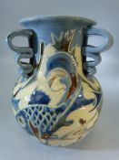 Early C H Brannam three handled vase decorated in blues with fish by James Dewdney.