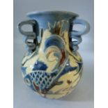 Early C H Brannam three handled vase decorated in blues with fish by James Dewdney.