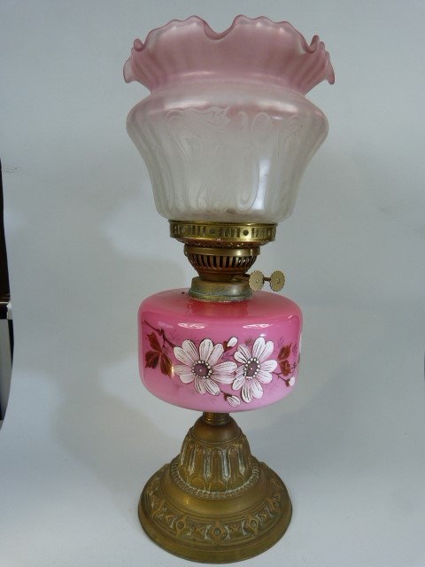 Edwardian Oil lamp with pink scallop edged shade. The Font decorated with hand-painted clematis type