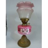 Edwardian Oil lamp with pink scallop edged shade. The Font decorated with hand-painted clematis type