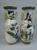 Japanese pair of twin handled vases decorated in oriental enamelled scenes.