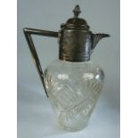 Cut Glass Claret Jug in the Manner of Christopher Dresser with Pewter fittings and star cut base.