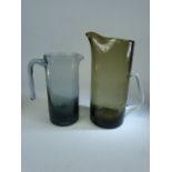 Holmegaard Danish glass water jugs in smokey glass. Both unmarked. 1 - approx height to spout