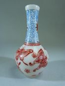 Peking glass bottle vase with enamelled blue and red decoration. Decorated with butterflies and