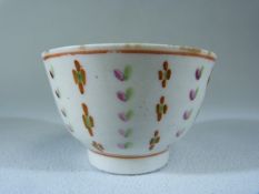 Miniature (unmarked) Sake cup. Decorated in underglaze Ochre, Green and Pink with floral stripes.