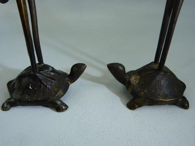 Bronze candlesticks modelled as a pair of cranes standing upon the back of Tortoises. Poss Chinese. - Image 3 of 3